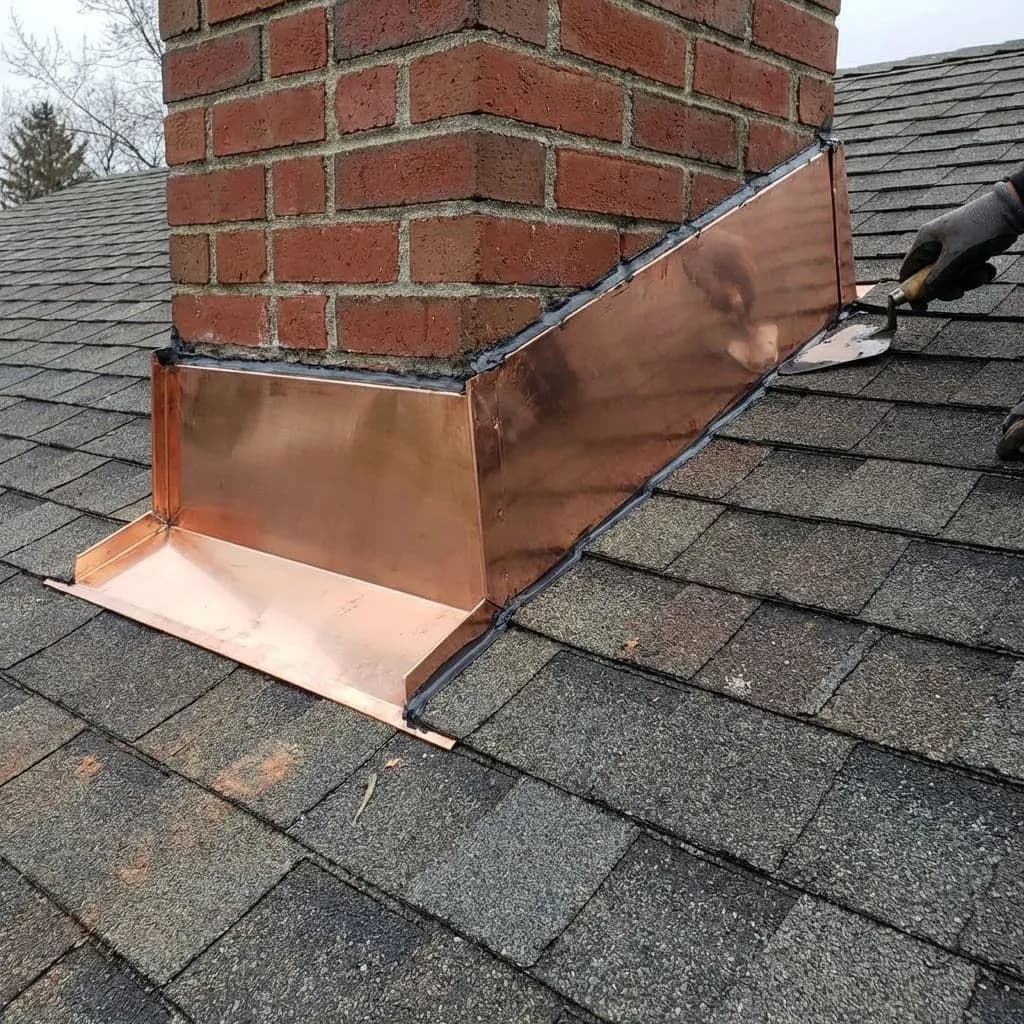 Professional chimney flashing repair detail on a shingle roof